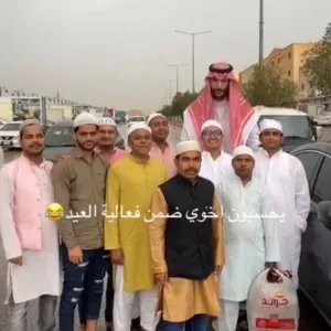 شاهد.. مقيمون يلتقطون صورة تذكارية مع مواطن طويل القامة أثناء احتفالهم بالعيد